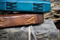 Close up of stack isolated blank spine of three old blue and brown books with vintage leather binding Royalty Free Stock Photo