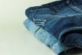 Close up of stack of jeans or denim pants isolated on white background. Royalty Free Stock Photo