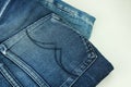 Close up of stack of jeans or denim pants isolated on white background. Royalty Free Stock Photo