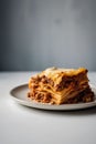 Close up of a stack of lasagna bolognese on a plate