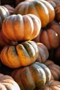 Close up stack lot of Autumn scenic pumpkins at outdoor farmers market on display for sale ready for Halloween. Autumn background