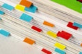 Close-up of stack of magazines with colored labels as bookmarks made with small colored papers Royalty Free Stock Photo