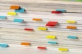 Close-up of stack of magazines with colored labels as bookmarks made with small colored papers Royalty Free Stock Photo