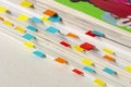 Close-up of stack of magazines with colored labels as bookmarks made with small colored papers Royalty Free Stock Photo