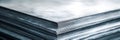 A closeup of a stack of metal sheets showcasing their sleek silver surface The sheets are arranged neatly highlighting the Royalty Free Stock Photo