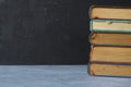 Close-up of stack of old used books background. Pile of vintage old hardback books. Back to school. Copy space