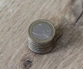 Stack of one euro coins on wooden background Royalty Free Stock Photo