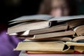 Close-up of a stack of open books on a blurred background.