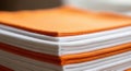 Close up stack of orange and white documents showing paper texture and layers Royalty Free Stock Photo
