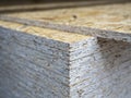 Close-up of a stack of OSB sheets. Lumber, construction, selective focus