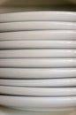 Close up of a stack of plain white plates