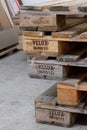 Close-up stack of shipping pallets with Velux inscription lying on the cement floor, selective focus Royalty Free Stock Photo