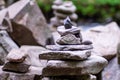 Close-up of a stack of stones in perfect balance in a mountain forest. Cairn, art of balancing rocks.