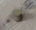 Stack of ten euro cent coins on wooden background Royalty Free Stock Photo