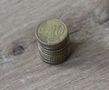 Stack of ten euro cent coins on wooden background Royalty Free Stock Photo