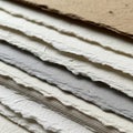 A close-up of a stack of textured, handmade papers with deckle edges Royalty Free Stock Photo