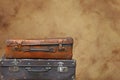 Old vintage travel suitcases over brown paper Royalty Free Stock Photo