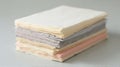 Close up of a Stack of Various Colored Papers on a Light Grey Surface Royalty Free Stock Photo