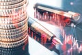 Close up of stacked coins and fountain pen on desktop with glowing falling red forex chart on blurry backdrop. Stock exchange and Royalty Free Stock Photo