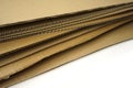 Close-up of stacked corrugated cardboard on white background Royalty Free Stock Photo