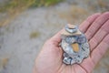 Hand holding stacked pebbles