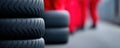 stack of car tires with blurred shapes in a red dress. Royalty Free Stock Photo