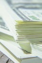 Close up of stacks of hundred US Dollar bills. Shot with shallow depth of field. Selective focus