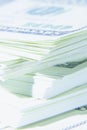 Close up of stacks of hundred US Dollar bills. Shot with shallow depth of field. Selective focus. Vertical image