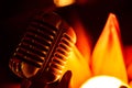 Close-up stage retro microphone, orange tint, different focus.