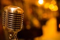 Close-up stage retro microphone, orange tint, different focus, copy space. Royalty Free Stock Photo