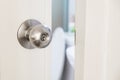 Close-up stainless door knob, with door open slightly Royalty Free Stock Photo