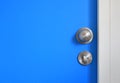 Close-up Stainless knob and latch on blue door with copy space