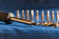 Close-up of a stainless screwdriver. Various screwdriver heads, including screws, nuts and nails placed on a blue denim Royalty Free Stock Photo