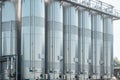 Close up of stainless vertical steel storage tanks for wine fermentation and maturation in modern winery factory