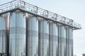 Close up of stainless vertical steel storage tanks for wine fermentation and maturation in modern winery factory Royalty Free Stock Photo