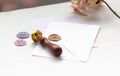 Close-up of a stamp. Envelope and wax seal in different colors with the inscription - love
