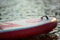 Close up of a stand up paddle board SUP and paddle on a dock