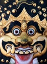 Close up of staring golden and black mask with fangs, Java, Indonesia