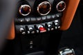 Close up of start and stop ignition buttons placed on dashboard of modern sports automobile interior. Technological