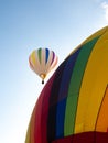 Close Up of a Stationery Hot Air Balloon with One in Flight in t Royalty Free Stock Photo