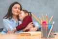 Close-up stationery set on the table. On the background of mother and daughter who embraced herself. Broken. Gray Royalty Free Stock Photo