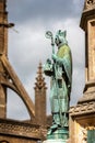 Close up of statue of Bishop Roger on the Digby Memorial Cross in front of Sherborne Abbey in Sherborne, Dorset, UK