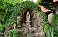 Statue of Our lady of grace virgin Mary view with natural background in the rock cave at Thailand. selective focus. Royalty Free Stock Photo