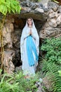 Statue of Our lady of grace virgin Mary view with natural background in the rock cave at Thailand. selective focus. Royalty Free Stock Photo