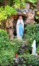 Statue of Our lady of grace virgin Mary view with natural background in the rock cave at Thailand. selective focus. Royalty Free Stock Photo