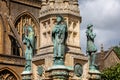 Close up of statues of Sir Francis Drake, St Aldhelm and Bishop Roger on the Digby Memorial Cross in front of Sherborne Abbey in