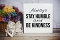 `Always Stay Humble and Be Kindness` Inspirational and motivational quote with flower decoration on marble background