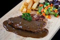 Close up steak pork with black pepper sauce, french fries Royalty Free Stock Photo