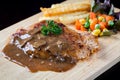 Close up steak pork with mushroom sauce, french fries and salad Royalty Free Stock Photo