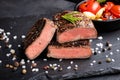 Close-up of steak Top Blade roasting medium ready to eat on dark stone background Royalty Free Stock Photo